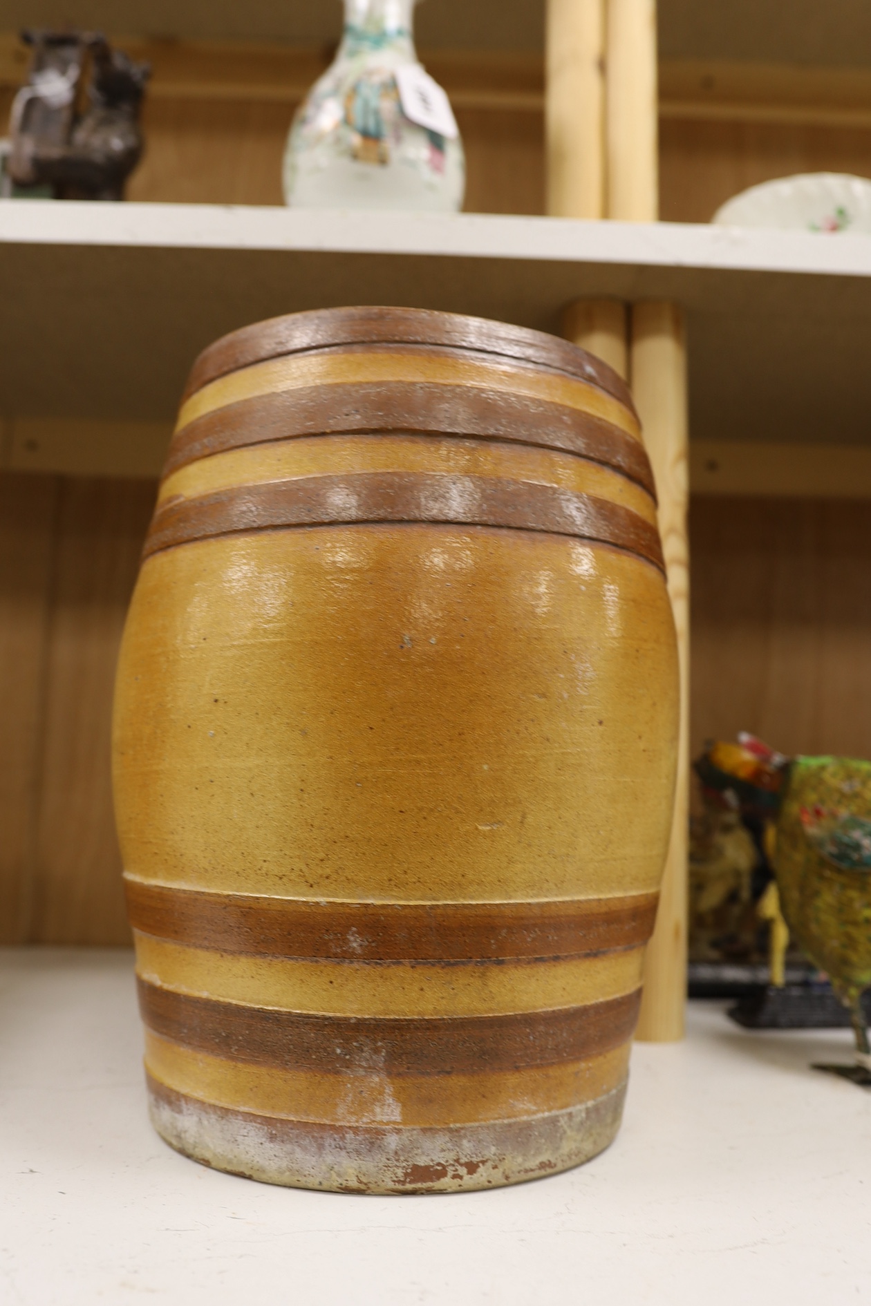 A Doulton and Watts stoneware spirit barrel, applied with the Royal coat of arms, 33.5cm high. Condition - some scratches in the glazing and marks on band by tap aperture